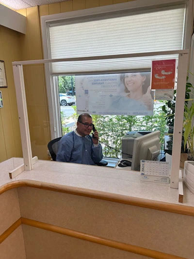 Dentist talking on the phone about a smile makeover in Bethesda, MD